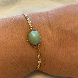 Artisan Delicate gold braided wire bracelet with a light green bead